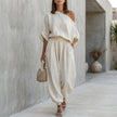 White FJØRNA draped one-shoulder top with voluminous lantern pants 2-piece set, perfect for resort chic fashion.
