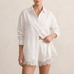 FJØRNA white two-piece shirt and shorts set with lace trim, classic collar, relaxed fit, perfect for casual summer wear.