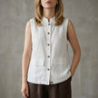 White sleeveless denim summer blouse for women with button front by FJØRNA, styled with casual neckline and fit.