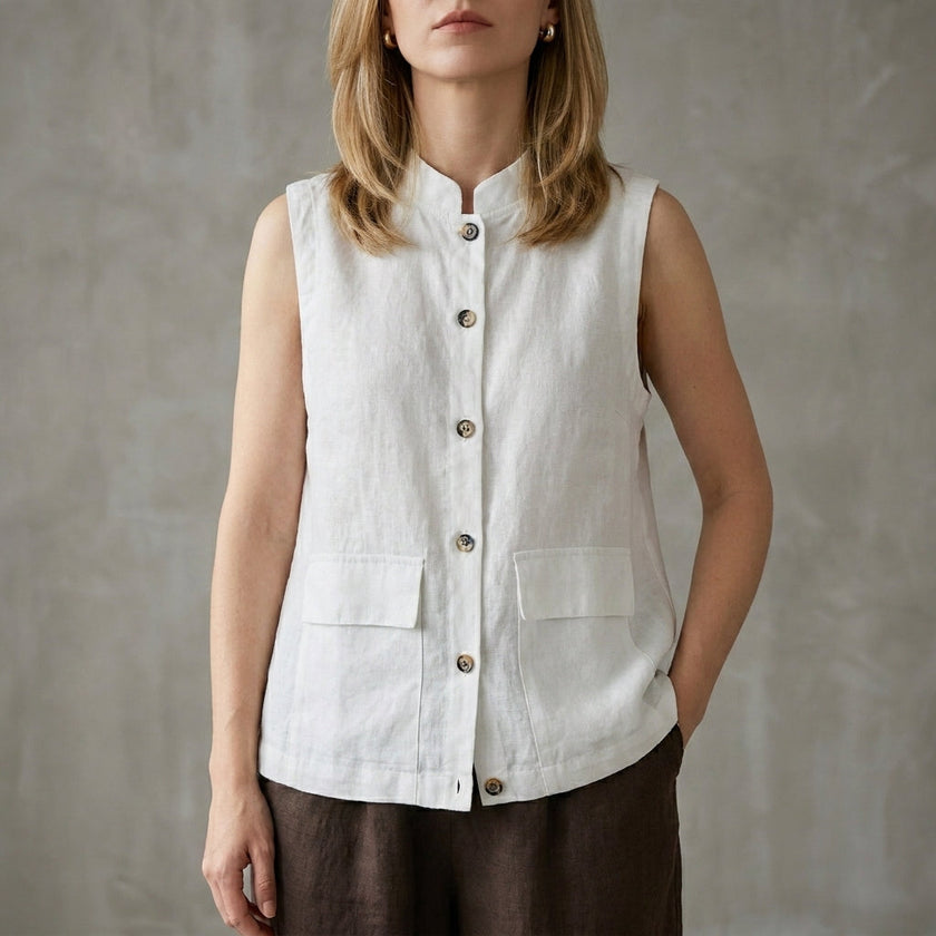 White sleeveless denim summer blouse for women with button front by FJØRNA, styled with casual neckline and fit.
