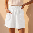 White women's linen summer shorts with pockets, casual fit, featuring a relaxed style by FJØRNA.