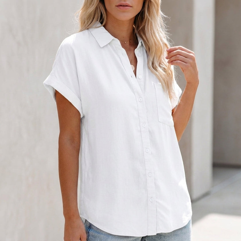 White FJØRNA women's collared button-up blouse with cuffed sleeves and chest pocket, styled on a model.