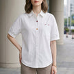 White women's summer blouse with puff sleeves and denim fabric, featuring button front and casual style by FJØRNA.