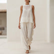 White semi-sheer two-piece set with flowing fabric, draped wide-leg trousers and matching top by FJØRNA.