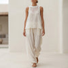 White semi-sheer two-piece set with flowing fabric, draped wide-leg trousers and matching top by FJØRNA.