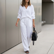 White oversized two-piece crinkle-texture suit with relaxed fit and drawstring waist by FJØRNA, featuring a stylish and comfortable silhouette.