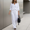 White oversized two-piece crinkle-texture suit with relaxed fit and drawstring waist by FJØRNA, featuring a stylish and comfortable silhouette.