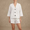 FJØRNA oversized white lounge set with button details, includes relaxed shorts and a matching top for comfortable casual wear