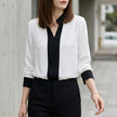 White FJØRNA women's summer blouse with V-neck, long chiffon sleeves, and a relaxed fit.