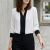 White FJØRNA women's summer blouse with V-neck, long chiffon sleeves, and a relaxed fit.