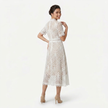 White women's lace midi dress by FJØRNA, high neck design with refined cutwork, shown from the back in a profile pose.
