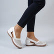 White FJØRNA orthopedic wedge sandals with scalloped trim and side cut-outs, featuring supportive design and stylish detailing.