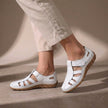 White FJØRNA orthopedic cutout fisherman sandals for women, featuring open heel and strap design with cutout details.