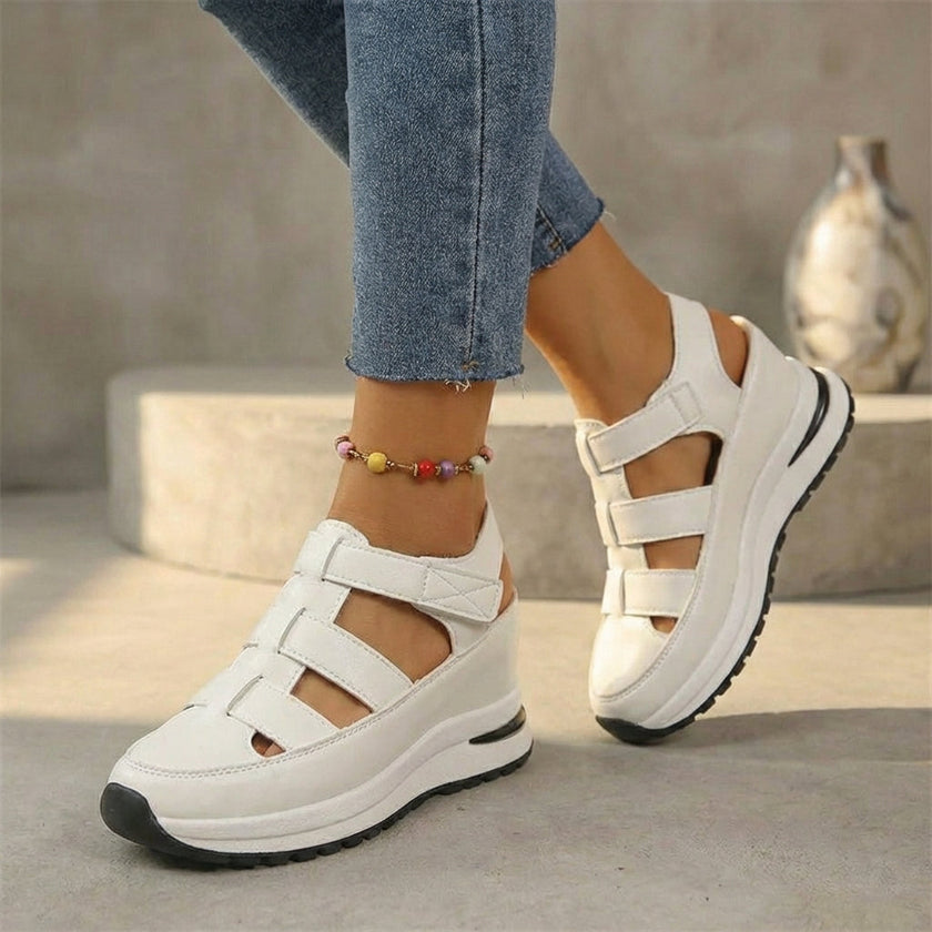 White FJØRNA orthopedic platform sandals with cutout design and closed-toe for comfort and support.