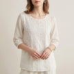 FJØRNA women's summer floral V-neck blouse in white, lightweight top with a feminine, flowy design for warm weather.
