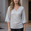 White FJØRNA women's summer blouse with V-neck and sequin embellishments, stylish top for warm weather.