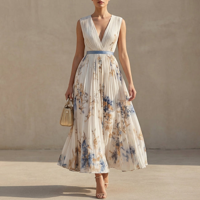 FJØRNA white pleated A-line maxi dress with V-neck and balloon sleeves, flowing fabric and elegant design.