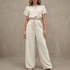 FJØRNA Coastal Breeze textured two-piece lounge set with white wide-leg pants, comfortable and stylish for relaxed wear.