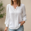 White FJØRNA women's pullover blouse with V-neck, lace trim, and pintuck texture, featuring a stylish and feminine design.