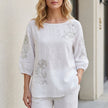White floral puff sleeve summer blouse for women by FJØRNA, featuring lightweight fabric and feminine design.