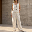 FJØRNA white sleeveless two-piece set with decorative buttons and wide-leg trousers, casual and stylish summer outfit.