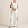 FJØRNA contrast trim two-piece set with relaxed wide-leg pants and matching top, in white fabric with stylish trim details.