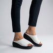 White FJØRNA orthopedic platform slide sandals with open toe and slip-on design, featuring cushioned footbed and chunky sole.