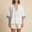 White geometric pockets summer two-piece set for women by FJØRNA, featuring a stylish coordinated top and shorts.