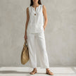 White minimalist sleeveless V-neck vest and flowing wide-leg pants set by FJØRNA, styled as a chic 2-piece outfit.
