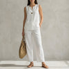 White minimalist sleeveless V-neck vest and flowing wide-leg pants set by FJØRNA, styled as a chic 2-piece outfit.