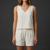 White FJØRNA women's summer two-piece pleated V-neck co-ord set featuring a stylish top and matching skirt.
