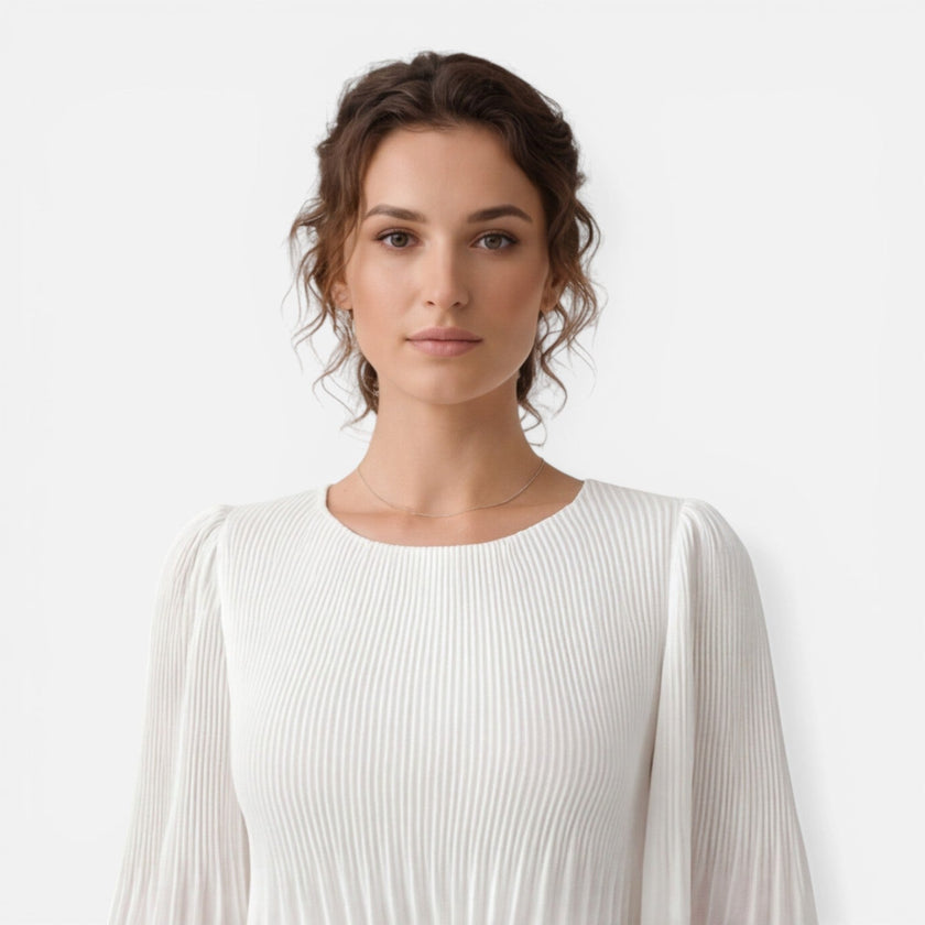 Women's white chiffon pleated maxi dress by FJØRNA, flowing design with pleats, suitable for wedding guests.