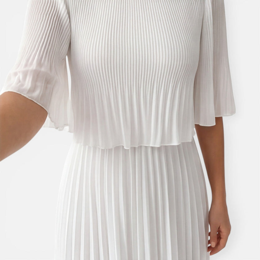 Women's white chiffon pleated maxi dress by FJØRNA, flowing style with pleats, perfect for wedding guests.