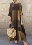 Women wearing FJØRNA khaki plaid maxi dress with o-neck, half sleeves, and ruffle detail in a casual outdoor setting.