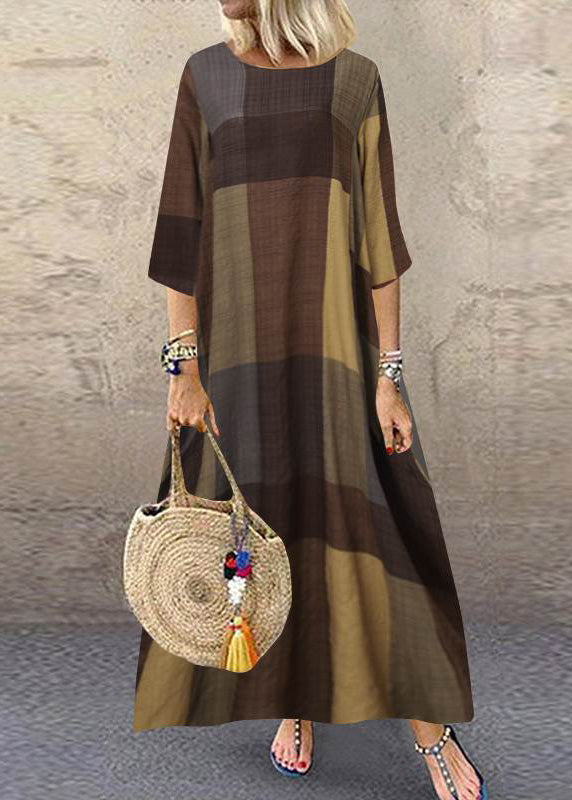 Women wearing FJØRNA khaki plaid maxi dress with o-neck, half sleeves, and ruffle detail in a casual outdoor setting.