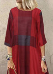 Women wearing FJØRNA khaki plaid maxi dress with O-neck, half sleeves, and ruffle details in a casual outdoor setting.