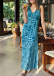 Women wearing a khaki V-neck patchwork print sleeveless evening dress by FJØRNA, styled for a party occasion.