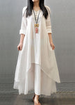 Women wearing FJØRNA white vintage maxi dress with long sleeves, double layers, button details, and asymmetric hem.