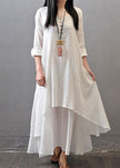 Women wearing FJØRNA long sleeve white vintage maxi dress with double layers, asymmetric button design, and elegant style.