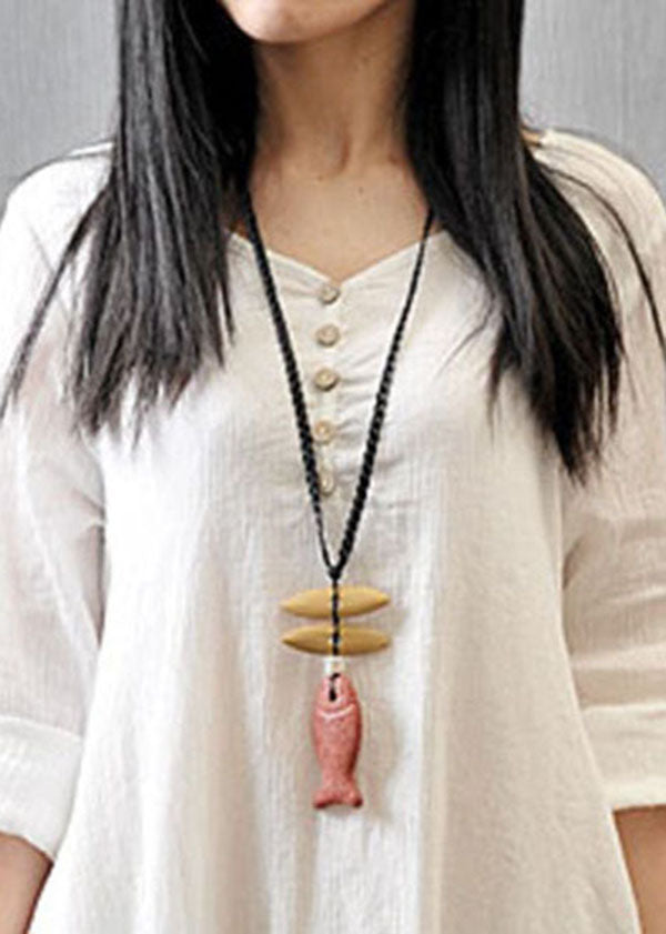 Women wearing a white FJØRNA long sleeve double layers button asymmetric vintage maxi dress with a flowing silhouette.