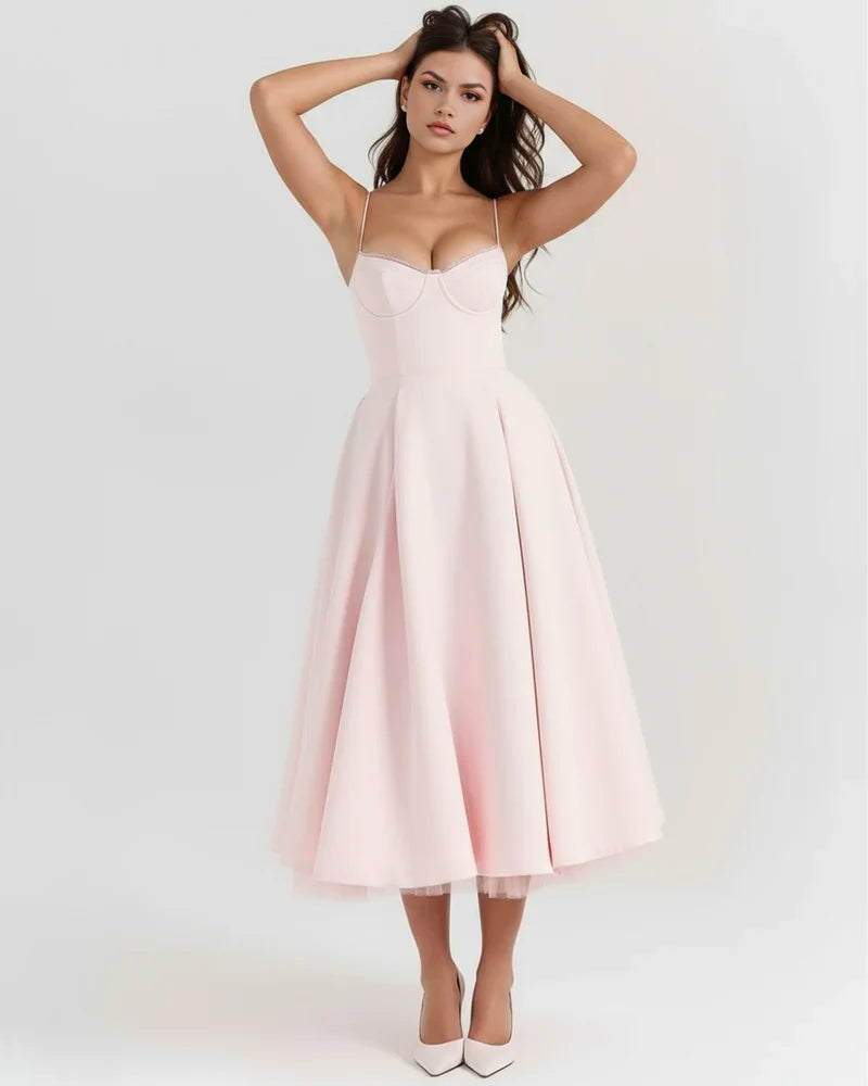 Women's corset midi dress with tulle skirt by FJØRNA, featuring a fitted bodice and flowing layered tulle for an elegant look.