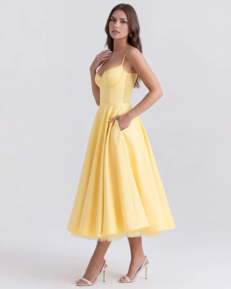 FJØRNA women's corset midi dress with a flowing tulle skirt, featuring a fitted bodice and elegant, layered design.