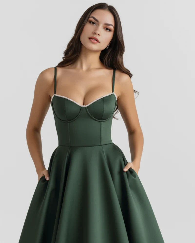 Woman wearing FJØRNA women's corset midi dress with a layered tulle skirt, showcasing elegant evening wear.