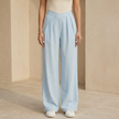 Women’s criss-cross waist wide-leg trousers by FJØRNA, showcasing stylish high-waisted design and flowing wide-leg fit.