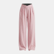 Women’s criss cross waist wide leg trousers by FJØRNA, featuring flowy fabric and stylish design, shown on a model.