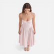 FJØRNA women's elegant midi A-line dress with straps, perfect for wedding guests, shown in a stylish, flowing design.