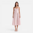 Women's elegant midi dress by FJØRNA featuring a strap A-line design, perfect for wedding guests, shown in a flattering silhouette.