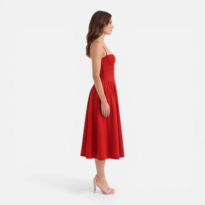 Elegant women's midi A-line dress by FJØRNA, featuring a strap design, suitable for wedding guests.
