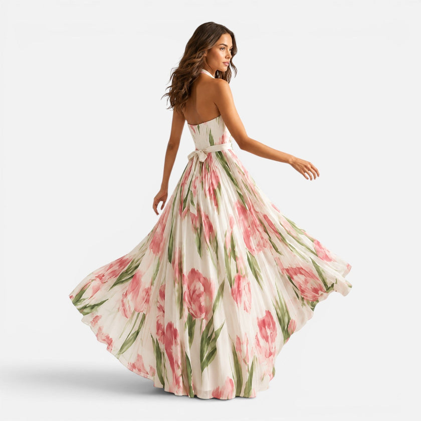 Women’s floral halter maxi dress by FJØRNA featuring a flowing design and vibrant floral pattern.
