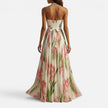 Woman wearing a floral halter maxi dress by FJØRNA, flowing design with vibrant floral pattern perfect for summer or casual wear.
